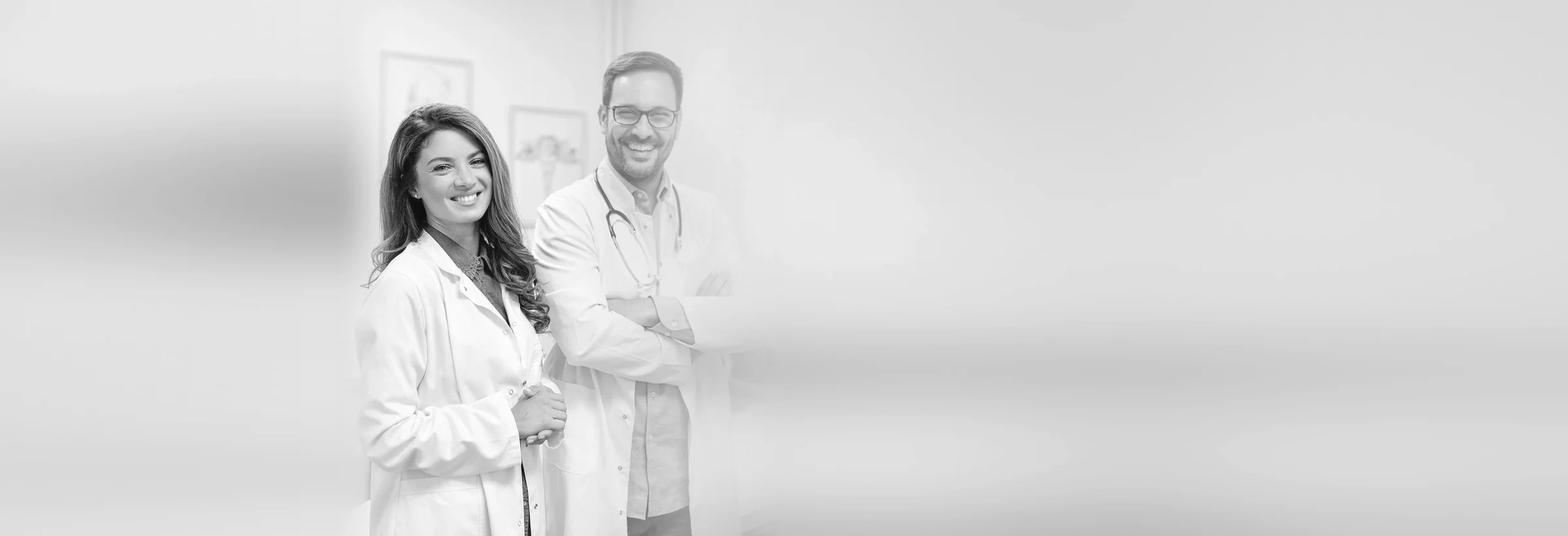 Dos profesionales sanitarios con bata blanca en una consulta
